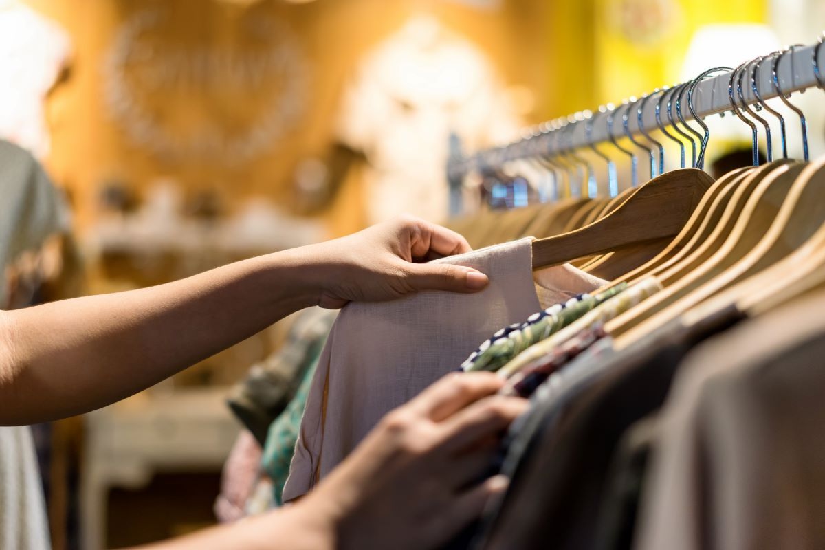 close-up-of-woman-hand-choosing-thrift-young-and-d-2023-11-27-04-55-33-utc
