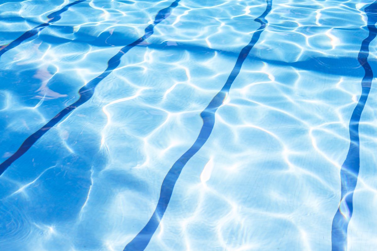 ripple-water-in-swimming-pool-with-sun-reflection-2023-11-27-05-03-31-utc