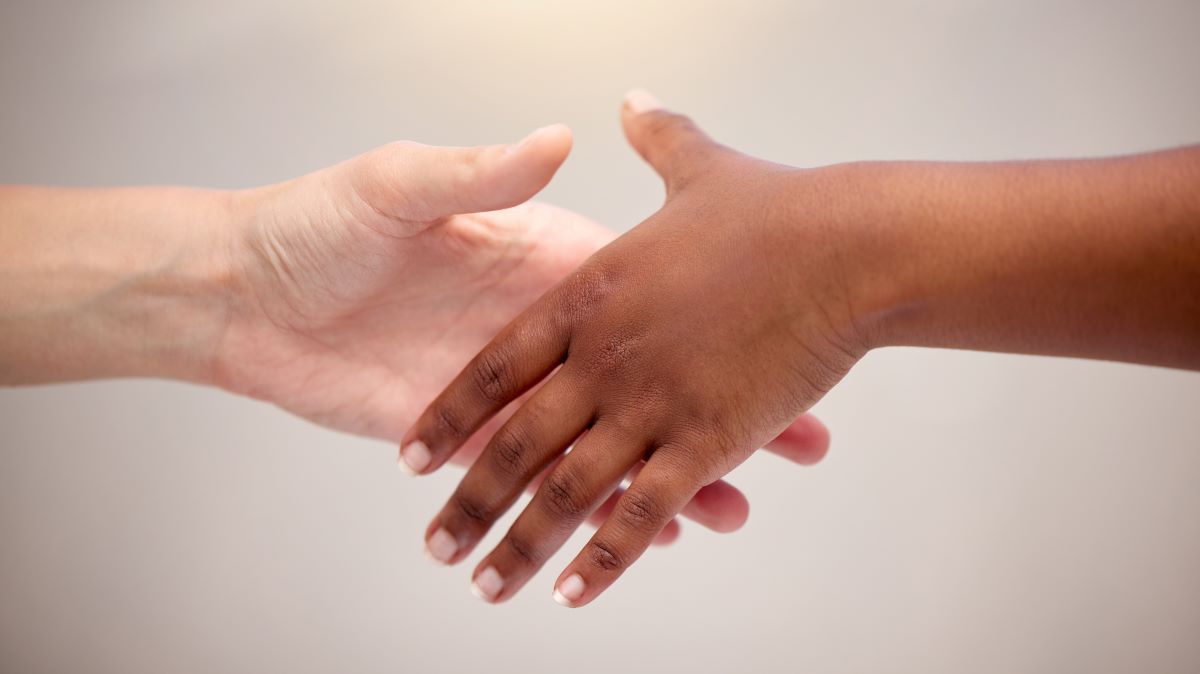 reaching-out-to-loved-ones-shot-of-two-people-rea-2023-11-27-04-51-29-utc